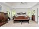 Spacious main bedroom with a tray ceiling, neutral carpet, and a large window at 690 Sienna Dr, Cumming, GA 30040