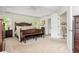 Spacious main bedroom with tray ceilings, neutral carpet, and a seating area at 690 Sienna Dr, Cumming, GA 30040