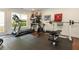Home gym equipped with treadmill, stationary bike, weights, and rubber flooring, perfect for fitness at 690 Sienna Dr, Cumming, GA 30040