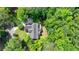 Scenic aerial shot of a well-maintained home with mature trees, landscaped yard, and private setting at 1595 Northcliff Trce, Roswell, GA 30076