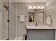 The bathroom features a glass shower door, marble countertop, and a grey cabinet at 1595 Northcliff Trce, Roswell, GA 30076