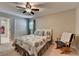 Bedroom with a quilted comforter on a bed, rocking chair, and double door closet at 1595 Northcliff Trce, Roswell, GA 30076