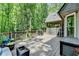 Wide wooden deck with a grill, string lights, and screened-in porch offers great backyard views at 1595 Northcliff Trce, Roswell, GA 30076