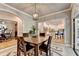 Dining room with hardwood floors and arched doorways leading into kitchen and living room at 1595 Northcliff Trce, Roswell, GA 30076