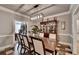 Formal dining room showcasing hardwood floors, modern light fixture, and classic china cabinet at 1595 Northcliff Trce, Roswell, GA 30076