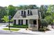Inviting home with dormer windows, black shutters, and a cozy front porch at 1595 Northcliff Trce, Roswell, GA 30076