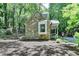 Charming stone cottage featuring a cozy front porch and surrounded by lush greenery at 1595 Northcliff Trce, Roswell, GA 30076