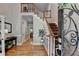 Inviting foyer with hardwood floors, staircase with wood railing, and entry door with ornate ironwork at 1595 Northcliff Trce, Roswell, GA 30076