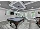 Finished basement featuring a pool table, foosball table, and ample space for entertainment at 1595 Northcliff Trce, Roswell, GA 30076