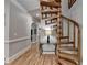 Hallway with a wooden spiral staircase, hardwood floors, and an elegant black table at 1595 Northcliff Trce, Roswell, GA 30076