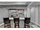 Modern kitchen featuring sleek gray cabinets, stainless steel appliances, and stylish bar seating for casual dining at 1595 Northcliff Trce, Roswell, GA 30076