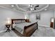 Cozy bedroom with a tray ceiling, a comfortable bed, and soft lighting at 1595 Northcliff Trce, Roswell, GA 30076