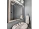 Stylish powder room with modern fixtures and a decorative mirror at 1595 Northcliff Trce, Roswell, GA 30076