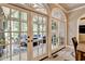 French doors open to the screened-in sunroom with outdoor seating at 1595 Northcliff Trce, Roswell, GA 30076