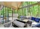 Bright screened-in sunroom with outdoor seating and wooded views at 1595 Northcliff Trce, Roswell, GA 30076