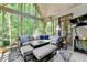 Comfortable screened-in sunroom with outdoor seating and wooded views at 1595 Northcliff Trce, Roswell, GA 30076