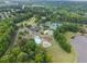 Aerial view showcasing the community amenities including a pool, tennis courts, playground, and lake access at 1721 Mulberry Lake Dr, Dacula, GA 30019