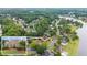 Aerial view of the neighborhood with beautiful houses, mature trees, and a lake at 1721 Mulberry Lake Dr, Dacula, GA 30019
