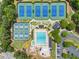 An aerial shot showcases a community pool, tennis courts, and recreation areas surrounded by green spaces at 1721 Mulberry Lake Dr, Dacula, GA 30019