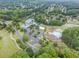 Aerial view showcasing community amenities: pool, tennis, playground, surrounded by lush greenery at 1721 Mulberry Lake Dr, Dacula, GA 30019