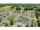 Aerial view of the clubhouse, parking, and adjacent golf course with lush green fairways, offering recreational options at 1721 Mulberry Lake Dr, Dacula, GA 30019