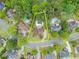 Aerial view of a beautiful home with in-ground pool surrounded by mature trees in a desirable neighborhood at 1721 Mulberry Lake Dr, Dacula, GA 30019