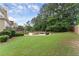 Expansive backyard featuring a well-maintained lawn and a cozy fire pit area, perfect for outdoor entertaining at 1721 Mulberry Lake Dr, Dacula, GA 30019