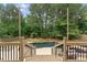 Picturesque view of a backyard pool from an elevated deck, highlighting the outdoor entertainment space and lush surroundings at 1721 Mulberry Lake Dr, Dacula, GA 30019