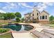 Gorgeous backyard pool and patio area, ideal for relaxation and outdoor enjoyment with plenty of space for lounging at 1721 Mulberry Lake Dr, Dacula, GA 30019