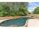 Scenic backyard featuring a beautiful pool, waterfall feature, and lush greenery, creating a serene and private retreat at 1721 Mulberry Lake Dr, Dacula, GA 30019