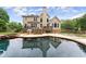 Private backyard featuring a large pool, deck, outdoor seating and lush greenery at 1721 Mulberry Lake Dr, Dacula, GA 30019