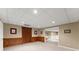 Spacious finished basement area with neutral walls and carpet, wainscoting, recessed lighting, and two doorways at 1721 Mulberry Lake Dr, Dacula, GA 30019