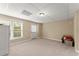 Finished basement space with neutral carpet, walk-out door and a large window for natural light, offering versatility at 1721 Mulberry Lake Dr, Dacula, GA 30019
