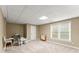 Finished basement area with neutral walls and carpet, recessed lighting, a window, and some furniture at 1721 Mulberry Lake Dr, Dacula, GA 30019