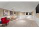 Finished basement offers a cozy seating area, a TV, recessed lighting, neutral walls, and plush carpeting at 1721 Mulberry Lake Dr, Dacula, GA 30019