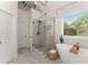 Beautiful primary bathroom featuring a soaking tub, separate shower, and a large window with natural light at 1721 Mulberry Lake Dr, Dacula, GA 30019