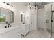 Chic bathroom featuring a soaking tub, separate shower, dual sinks, and black fixtures at 1721 Mulberry Lake Dr, Dacula, GA 30019