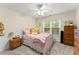 Cozy bedroom featuring a ceiling fan, and a bright window overlooking outside at 1721 Mulberry Lake Dr, Dacula, GA 30019