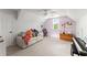 Bedroom with slanted ceilings, built in desk, comfortable sofa and neutral carpeting at 1721 Mulberry Lake Dr, Dacula, GA 30019