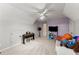 A carpeted bonus room features a ceiling fan, a television, and ample space for relaxation and entertainment at 1721 Mulberry Lake Dr, Dacula, GA 30019