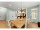 Dining room with light hardwood floors, a chandelier, and access to the back yard at 1721 Mulberry Lake Dr, Dacula, GA 30019