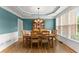 Elegant dining room with custom lighting, hardwood floors, and wainscoting at 1721 Mulberry Lake Dr, Dacula, GA 30019
