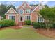 Beautiful brick two-story home with manicured lawn and mature landscaping at 1721 Mulberry Lake Dr, Dacula, GA 30019