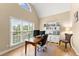 Bright home office featuring a large window, built-in shelving, and a comfortable workspace at 1721 Mulberry Lake Dr, Dacula, GA 30019