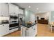 Kitchen featuring stainless appliances, granite counters and an island that connects to the dining area at 1721 Mulberry Lake Dr, Dacula, GA 30019