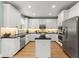 Bright kitchen featuring white cabinets, stainless steel appliances, and a center island at 1721 Mulberry Lake Dr, Dacula, GA 30019