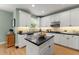 Kitchen showcasing white cabinetry, modern appliances, black countertops, and a stylish island at 1721 Mulberry Lake Dr, Dacula, GA 30019