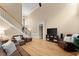 Open-concept living room with hardwood floors, neutral walls, and comfortable leather furniture at 1721 Mulberry Lake Dr, Dacula, GA 30019
