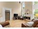 Cozy living room featuring hardwood floors, a fireplace, and comfortable leather armchairs at 1721 Mulberry Lake Dr, Dacula, GA 30019