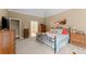 Spacious main bedroom with tray ceiling, a door to the ensuite bathroom, and large dressers at 1721 Mulberry Lake Dr, Dacula, GA 30019